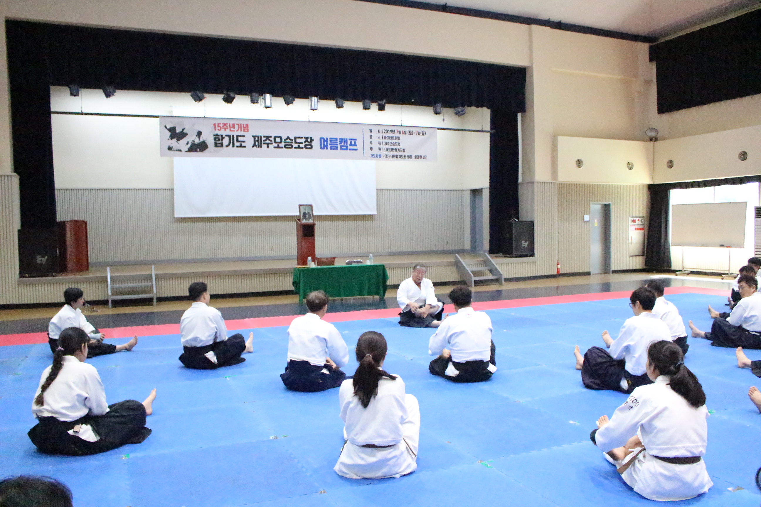 Members lined up training together at the Jeju Oseung Dojang camp